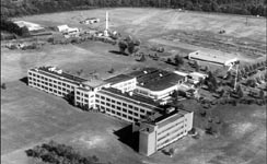 RCA Laboratories, Princeton, New Jersey is a collection of buildings 
that have been added on to the original T shaped building.  The top of the T faces the highway -- set back at least a quarter mile -- and the stem of the T 
(containing the machine shop and prototyping facilities extends away from the road.  The campus is centered on a large grassy and wooded site